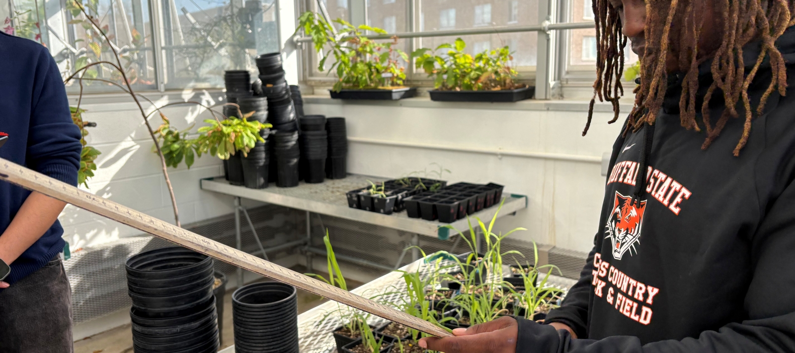 Biology student in greenhouse